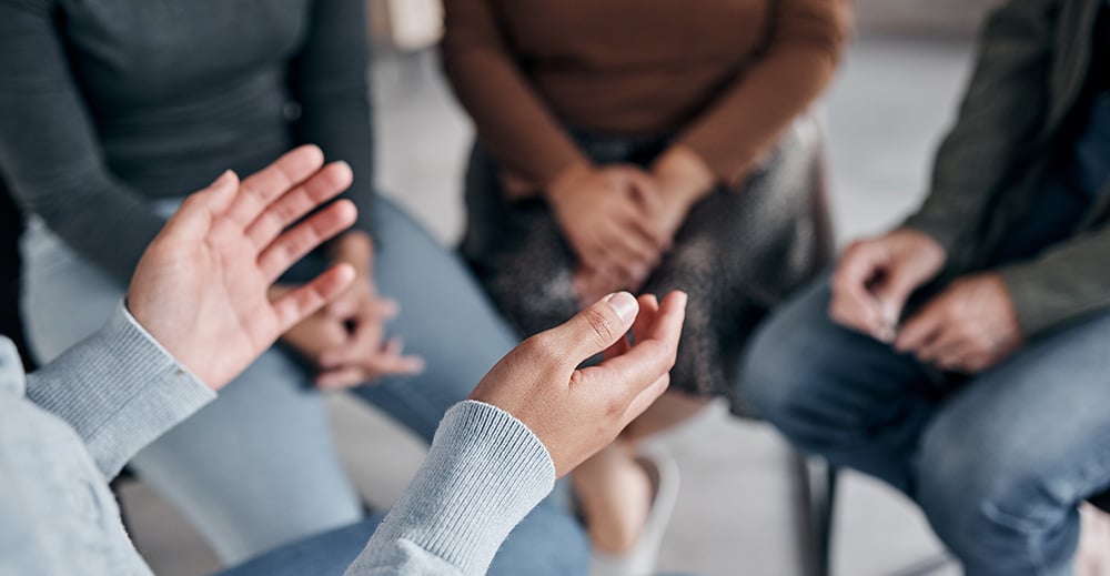 People participate in group therapy at a drug rehab.