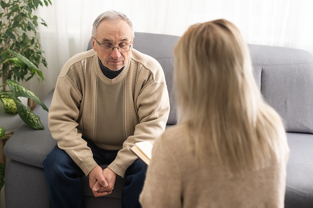 A retired professional participates in therapy as part of a drug rehab program.