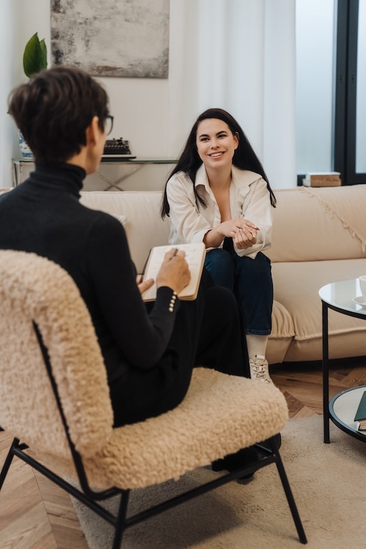 A woman participates in a therapy session at a drug rehab center.