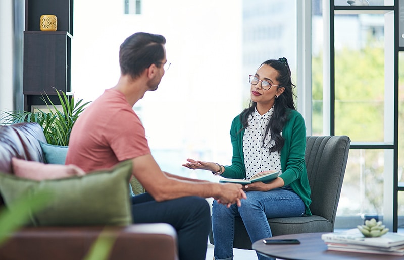 A client participates in a therapy session at a drug rehab.