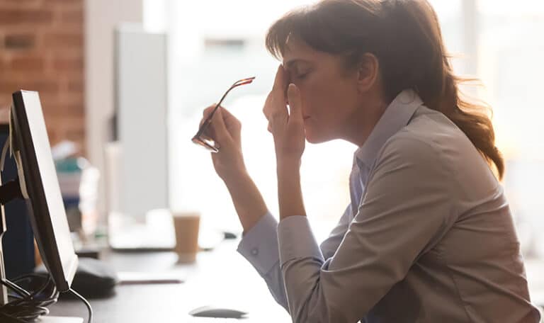 A woman struggles with anxiety while at work.