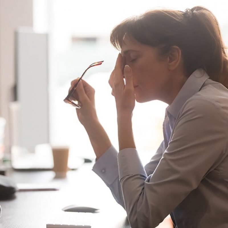 A woman struggles with anxiety while at work.